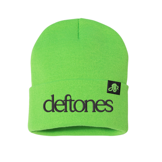 Bright neon green knit beanie with black embroidered ’deftones’ logo and a small black square patch featuring the band’s stylized snake emblem.