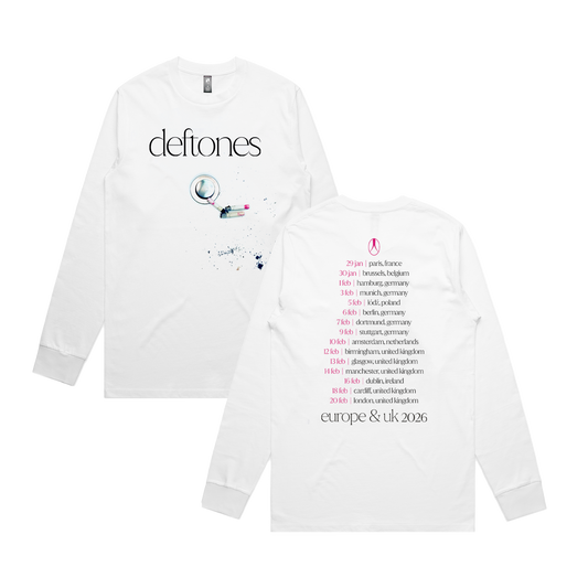 White long-sleeve t-shirt featuring the band name ’deftones’ and a graphic of a wine bottle with splatters, along with tour dates for europe & uk 2026 printed on the back.